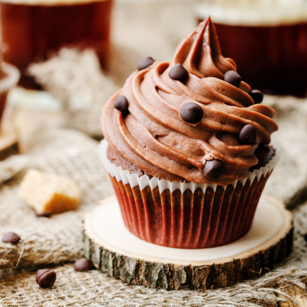 A cupcake with luscious chocolate frosting.