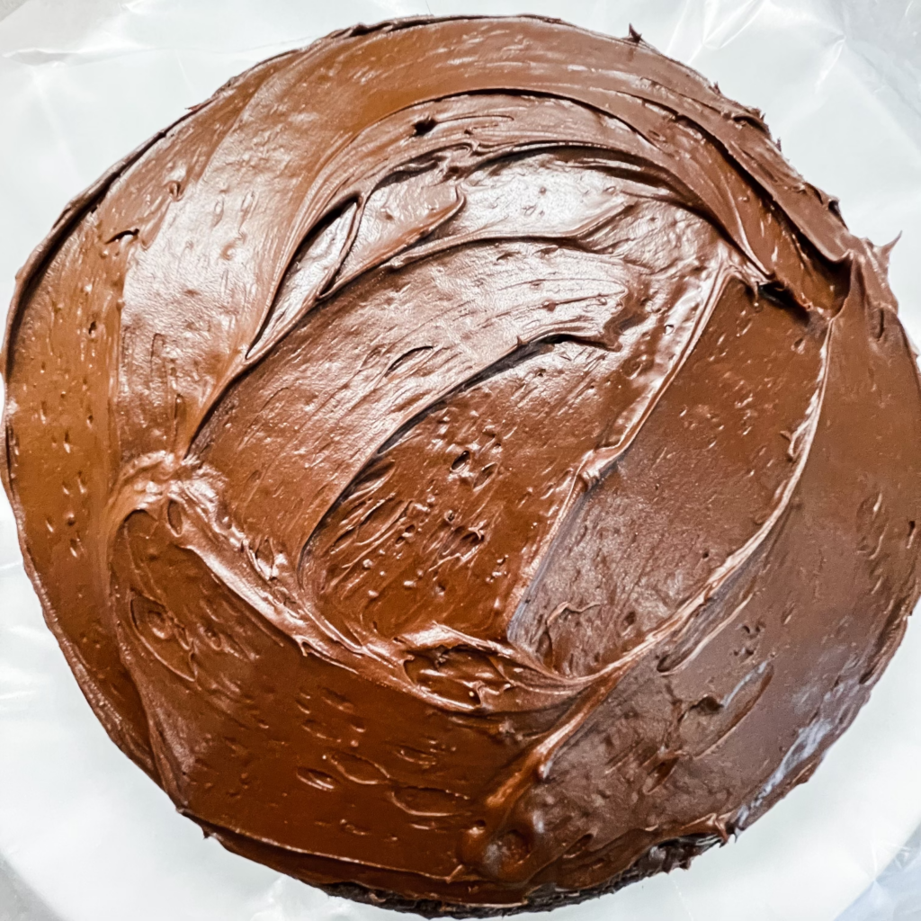 A round cake with chocolate frosting.