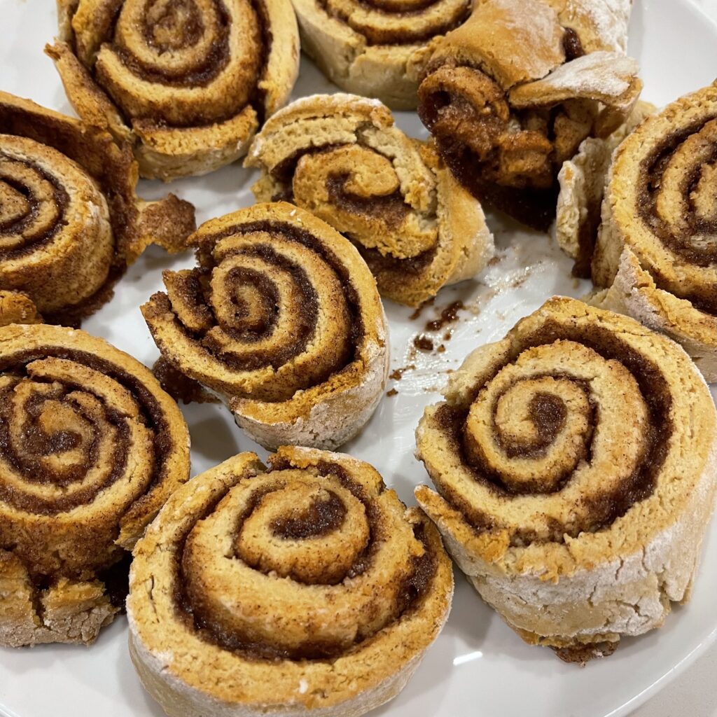 Plate of delicious, warm vegan gluten free cinnamon rolls.